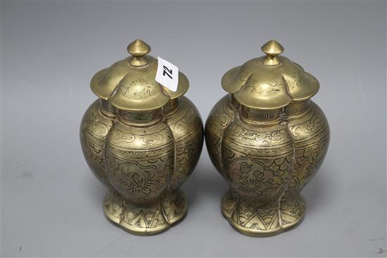 A pair of Chinese brass vases and covers, decorated with figures, cast seal marks to the bases, height 18cm